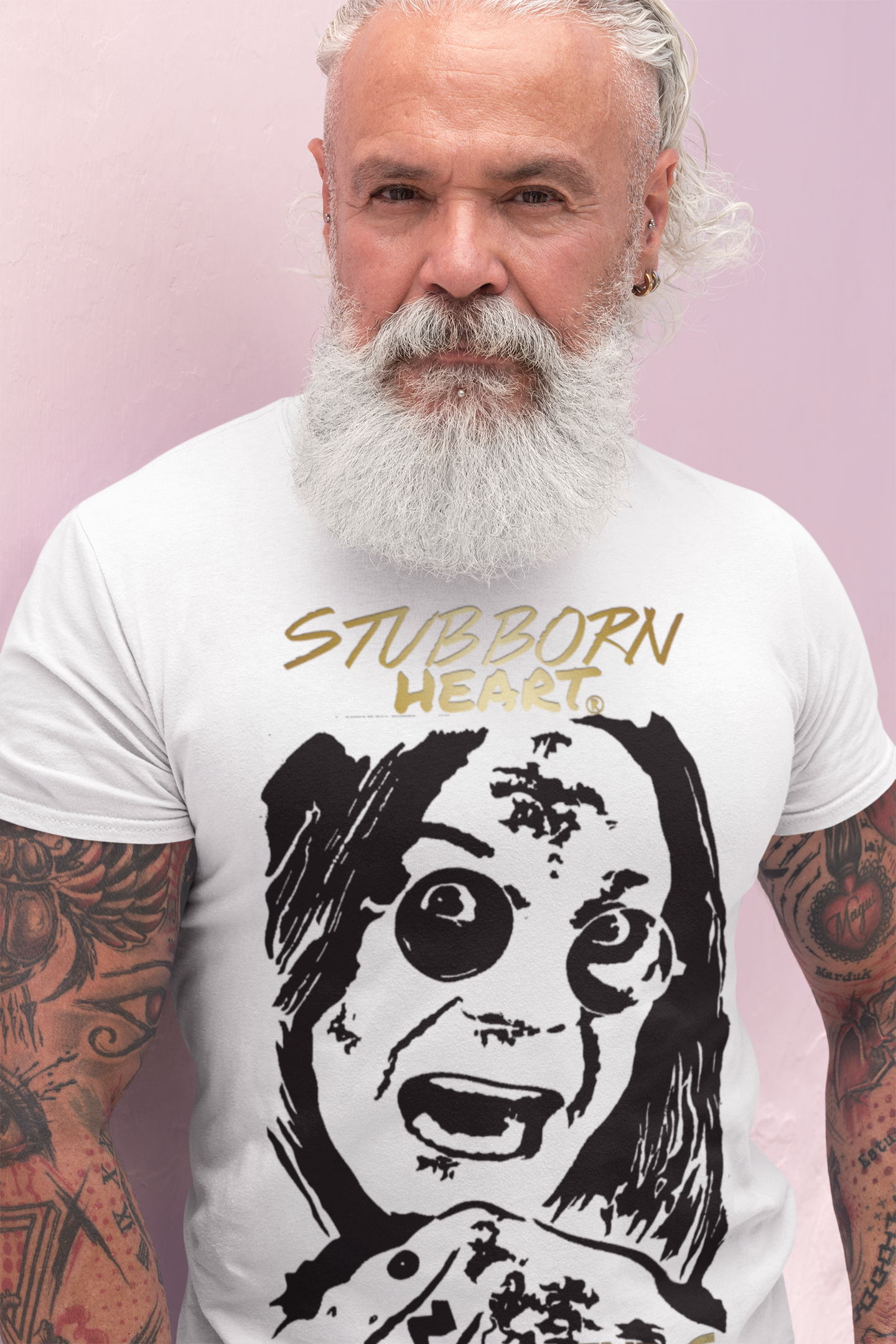 Older man with lots of arm tattoos wearing a LEGENDS COLLECTION: White T-Shirt designed by STUBBORN HEART Apparel with large full front art image of Ozzy Osbourne